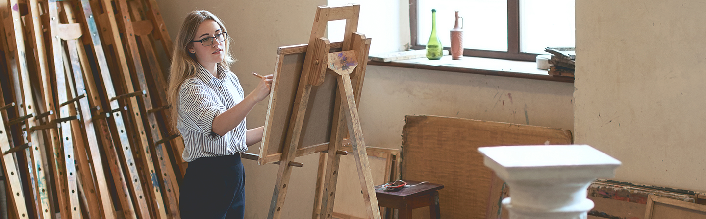 Art students painting in class