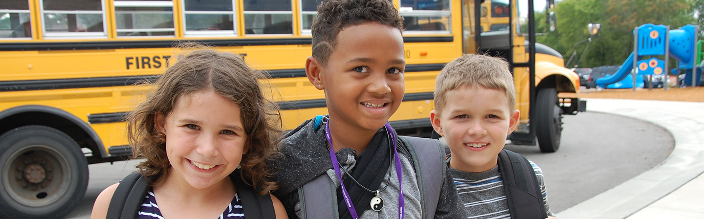 Students in front of the school bus on the first day of school. Students in front of the school bus on the first day of school.
