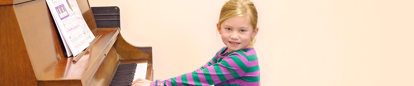 A young girl playing the piano